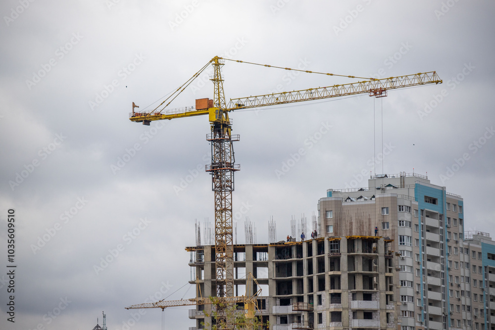 A crane is lifting a building under construction A crane is lifting a building under construction