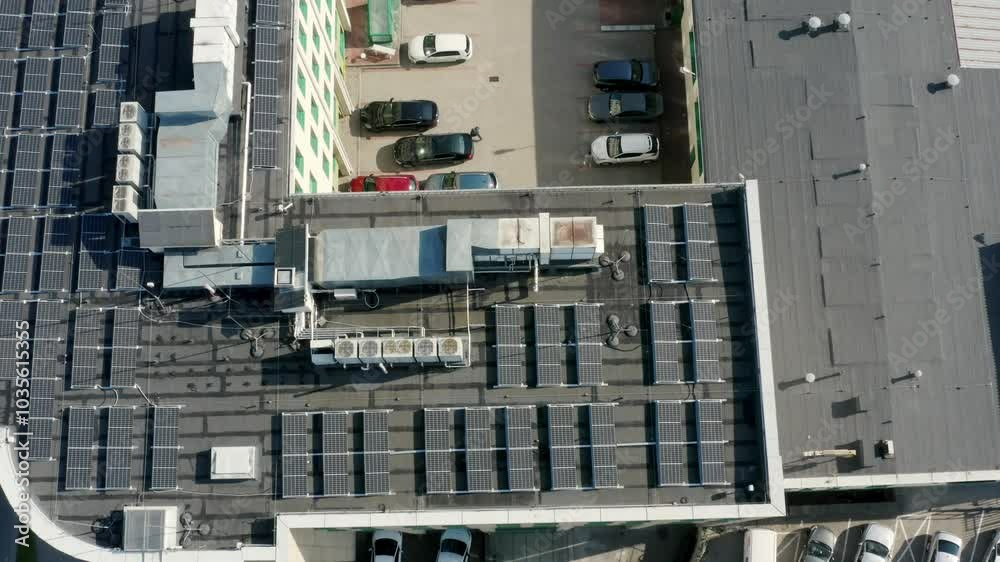 Solar panels on the roof of a multi story apartment building generating renewable energy, captured in this breathtaking aerial view.