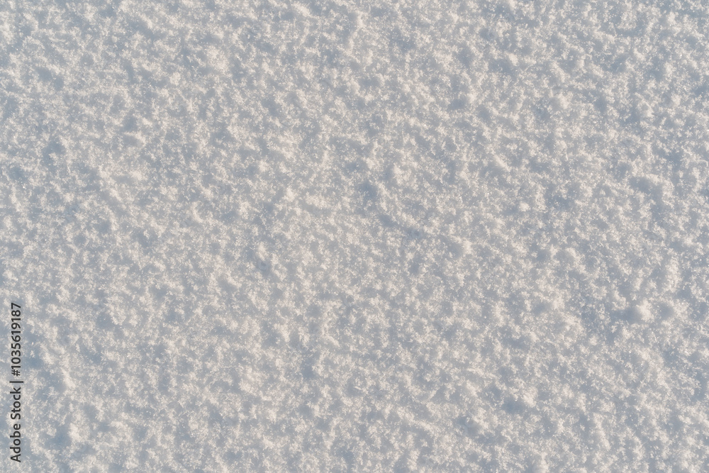 Natural snow texture. Smooth surface of clean fresh snow. Snowy ground.