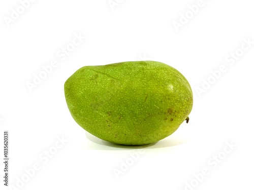 A single unpeeled whole organic fresh and ripe green mango fruit isolated on white background. Tropical fruit concept