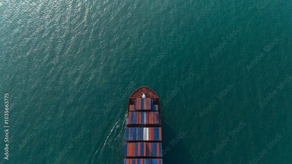 Aerial top view over international containers cargo ship at industrial import-export port prepare to load containers with big container loader ship vessel. global transportation and logistic business