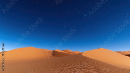 Starry night sky over sand dunes in the desert.