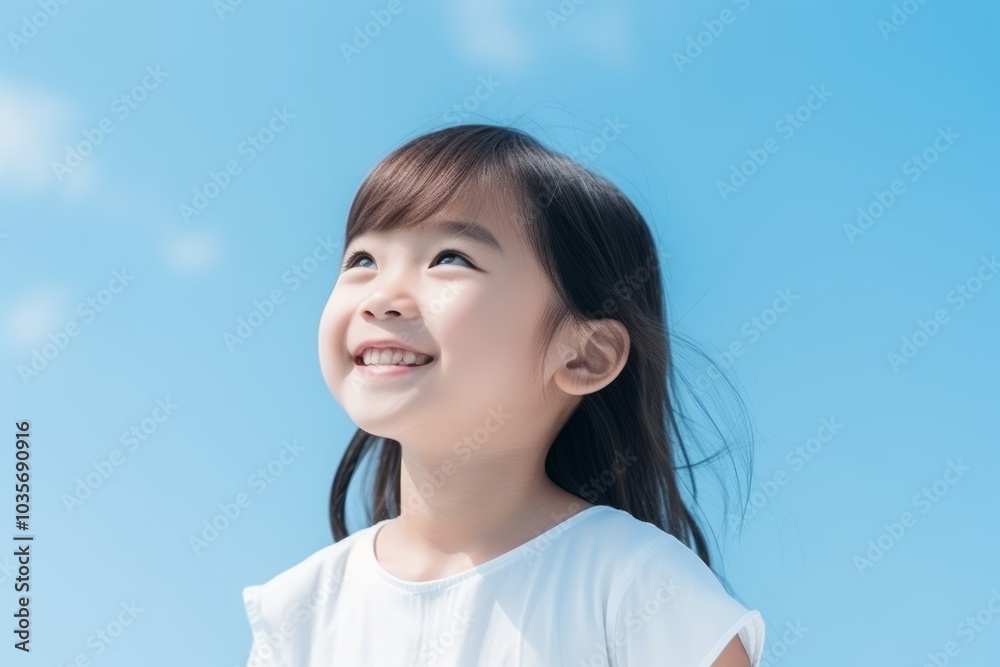 Portrait of a beautiful asian girl with blue sky background. Portrait of a beautiful asian girl with blue sky background.