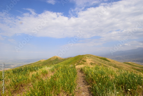 Road in the mountains on a sunny day with clouds 