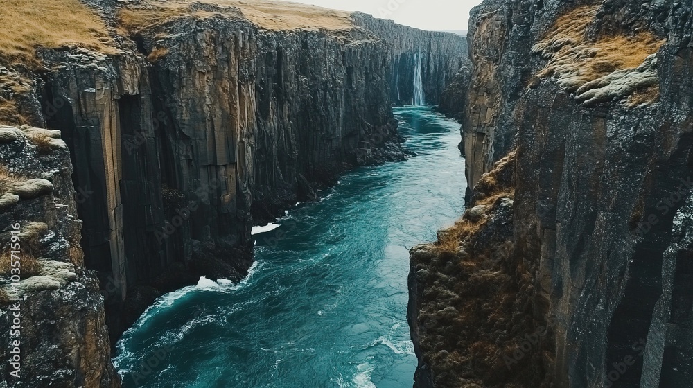 Naklejka premium A River Carving Through Icelandic Cliffs