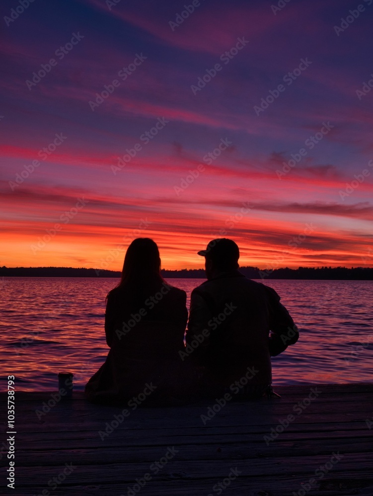 silhouette of a couple on a pier silhouette of a couple on a pier