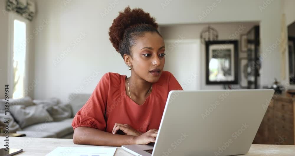 Pretty African woman sit at desk using laptop read great news, get commercial offer, sale and huge discounts, winning lottery or bet, received notification from bank about mortgage approval feel happy