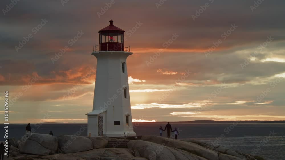 Stunning Timelapse Of Peggy's Cove Lighthouse At Dusk, Capturing The Dramatic Movement Of Clouds Over The Rocky Atlantic Coastline Near Halifax, Nova Scotia, Canada. Stunning Timelapse Of Peggy's Cove Lighthouse At Dusk, Capturing The Dramatic Movement Of Clouds Over The Rocky Atlantic Coastline Near Halifax, Nova Scotia, Canada.