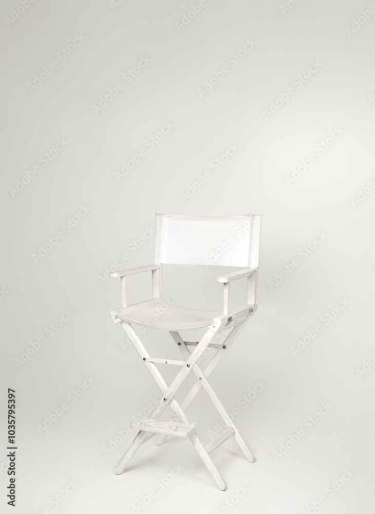 Fototapeta premium white director's chair in minimalist studio on white background
