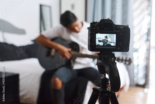 Camera, influencer and man with guitar in home for live streaming, music vlog and social media. Content creator, musician and person with musical instrument for talent, performance or creative skills