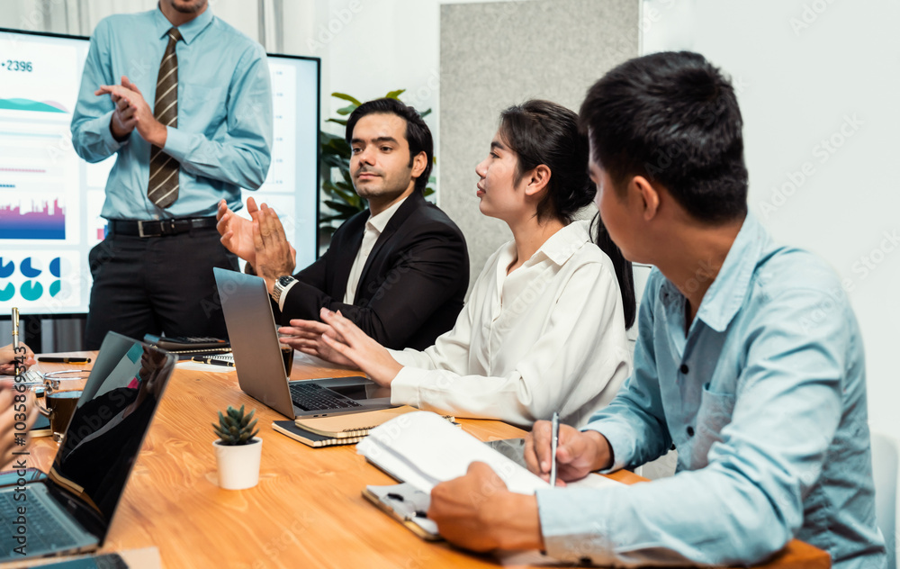 Fototapeta premium Group of happy multi ethnic businesspeople in celebratory gesture and successful teamwork after made success sales or positive financial data dashboard display on screen in meeting room. Habiliment