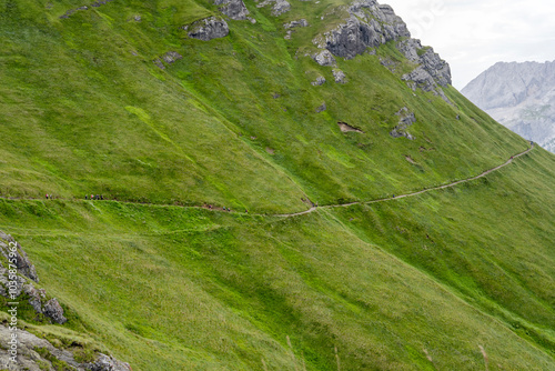 path  with hikers on Sass Ciapel  southern slope, Canazei,  Italy photo