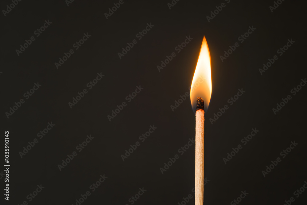 burning match on black background burning match on black background