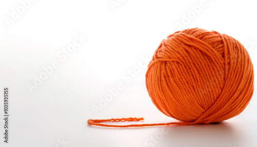 a Vibrant orange yarn ball on side position provides copy space for text. background concept isolated white