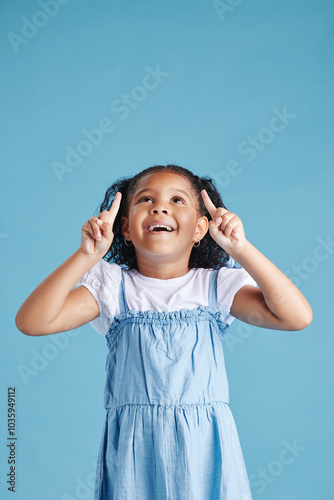 Studio, child and pointing with hands for marketing, product placement and branding by mockup space. Kid, girl and showing with gesture for advertising, sale or back to school deal by blue background