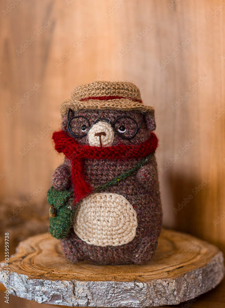 Fototapeta premium Knitted toy hedgehog in the interior, handmade toy miniature, selective focus