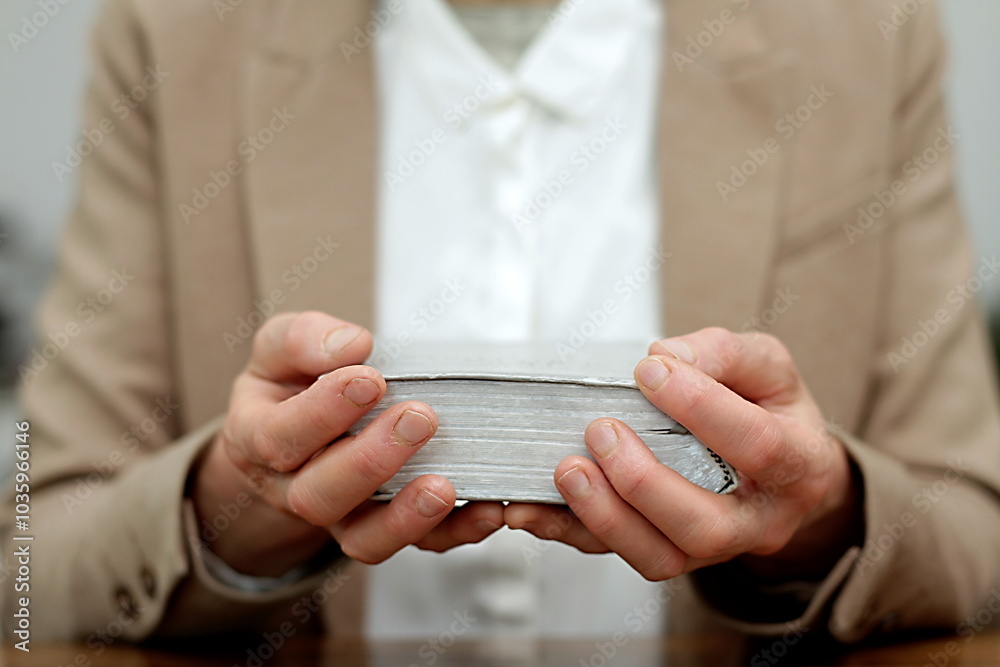 Obraz premium praying to god with hands together with crucifix cross on black background with people stock photo stock image 