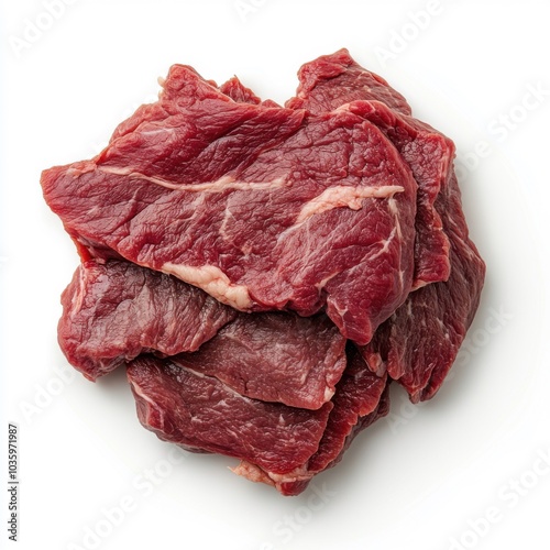 Fresh raw beef steak slices stacked on white background for culinary preparation
