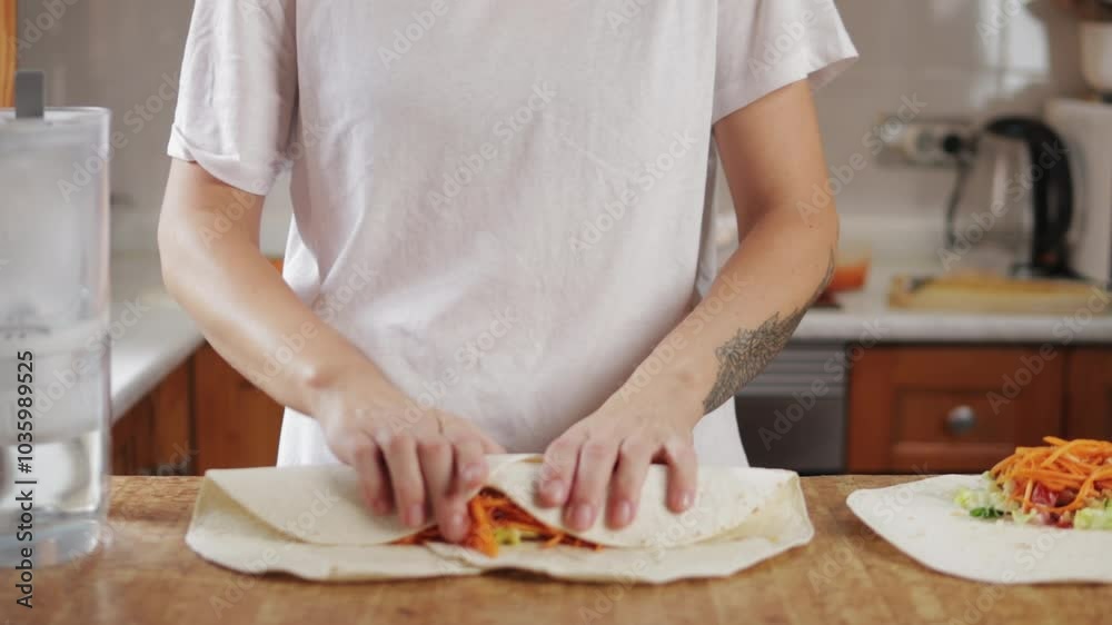 Chef skillfully wrapping tortilla around savory blend of meat and fresh vegetables creates mouthwatering burrito in lively kitchen filled with vibrant colors and fresh ingredients Chef skillfully wrapping tortilla around savory blend of meat and fresh vegetables creates mouthwatering burrito in lively kitchen filled with vibrant colors and fresh ingredients