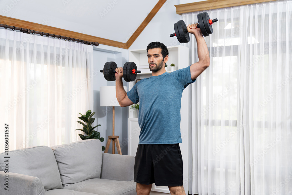 Athletic body and active sporty man lifting dumbbell weight for effective targeting muscle gain at gaiety home as concept of healthy fit body home workout lifestyle. Athletic body and active sporty man lifting dumbbell weight for effective targeting muscle gain at gaiety home as concept of healthy fit body home workout lifestyle.