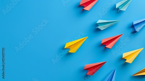 Colorful paper airplanes on blue background. Minimal creative concept.