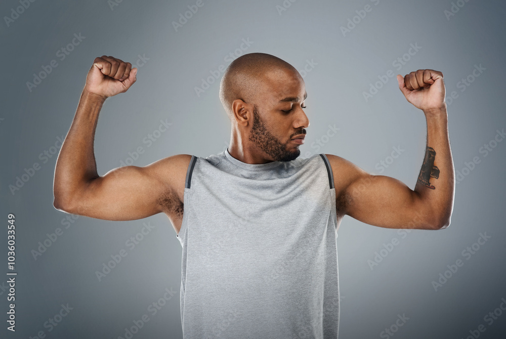 Muscle flex, black man and confident in studio for fitness, workout and exercise on gray background. Male person, serious and trainer with sportswear with training for health, wellbeing and self care Muscle flex, black man and confident in studio for fitness, workout and exercise on gray background. Male person, serious and trainer with sportswear with training for health, wellbeing and self care