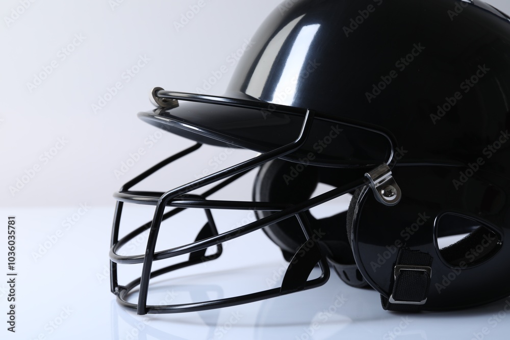 Black baseball helmet on light background, closeup Black baseball helmet on light background, closeup