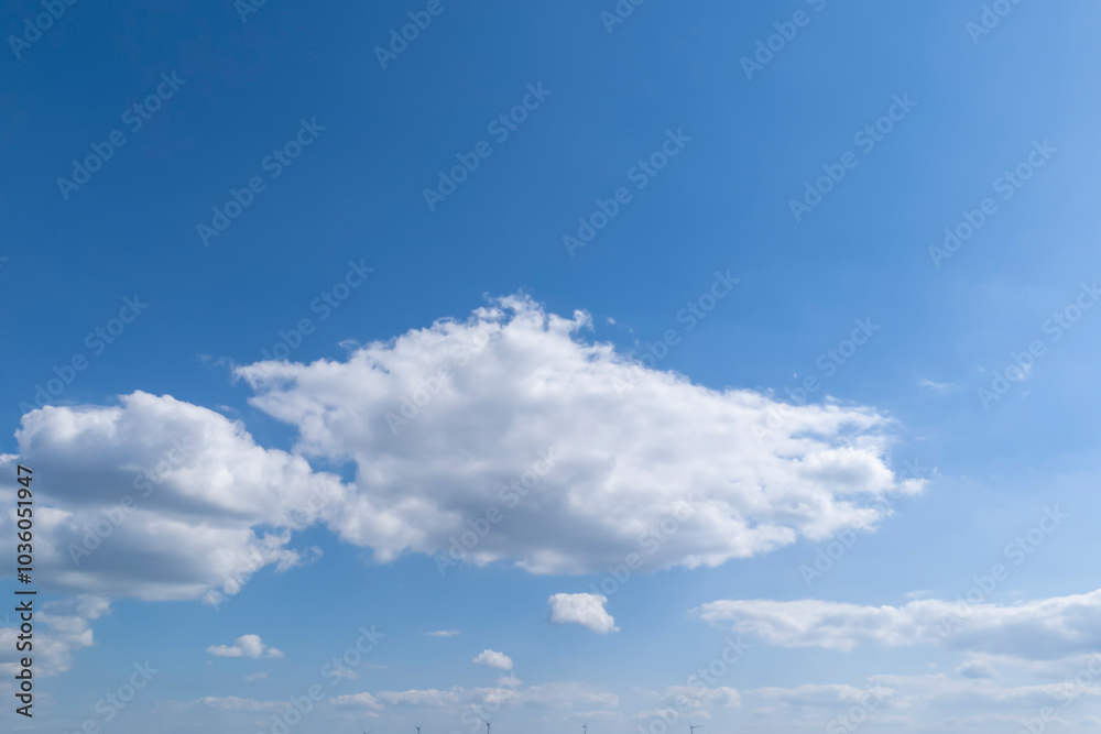 A clear blue sky with fluffy white clouds, creating a serene and peaceful atmosphere. Perfect for backgrounds or nature themes. A clear blue sky with fluffy white clouds, creating a serene and peaceful atmosphere. Perfect for backgrounds or nature themes.