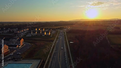 Drone video showing cars on a street at dusk.