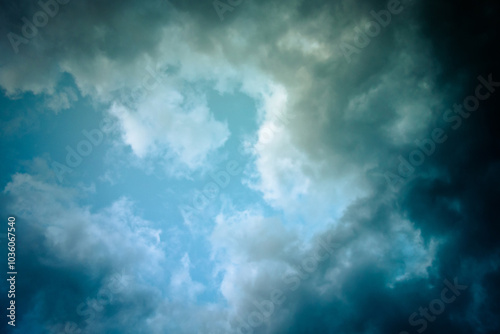 Dramatic cloud formation against a vibrant blue sky, suggesting a brewing storm or transition in weather.