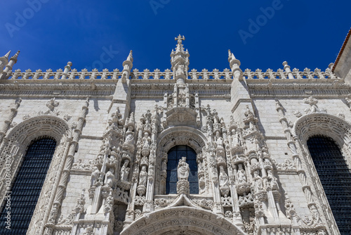 Manueline style, architectural details of Jeronimous Monastery, Lisbon, Portugal against blue sky.
