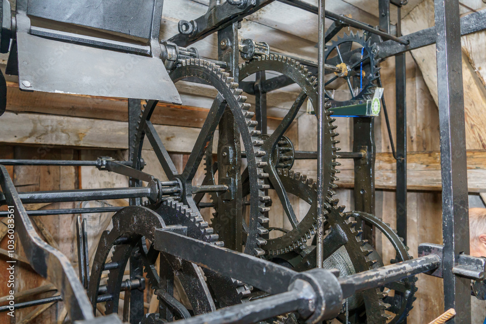 Church clockwork. The gear mechanism of a large old tower clock. Antique large clock mechanism with gears and cogs after restoration Church clockwork. The gear mechanism of a large old tower clock. Antique large clock mechanism with gears and cogs after restoration