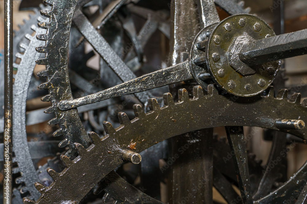 Church clockwork. The gear mechanism of a large old tower clock. Antique large clock mechanism with gears and cogs after restoration Church clockwork. The gear mechanism of a large old tower clock. Antique large clock mechanism with gears and cogs after restoration