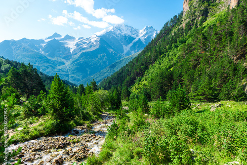 Beautiful mountain landscape in the valley of the stormy clean river Terskol with a view of the glacier 