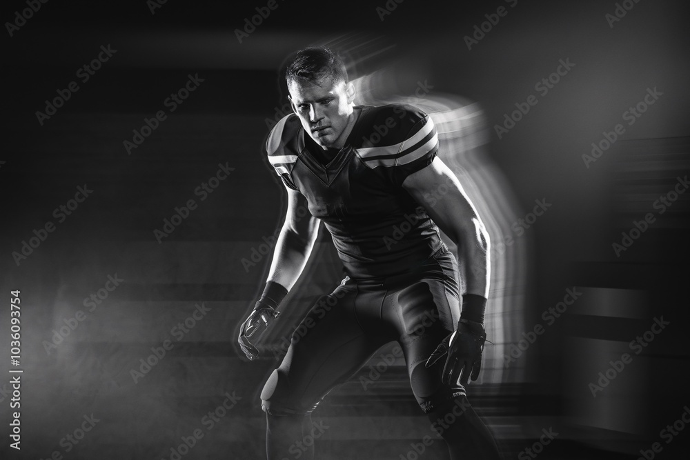 Football Player in Motion: A powerful black and white image of a determined American football player in action, his form captured in a blur of motion, evokes strength, speed. Football Player in Motion: A powerful black and white image of a determined American football player in action, his form captured in a blur of motion, evokes strength, speed.