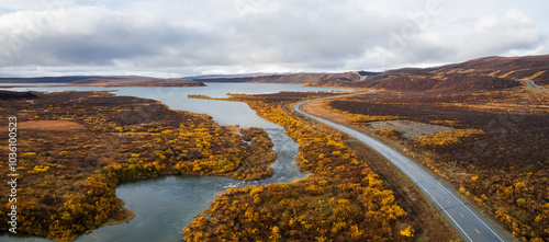 Aerial view of Richerdson highway passing through tundra in Alaska during autumn time.