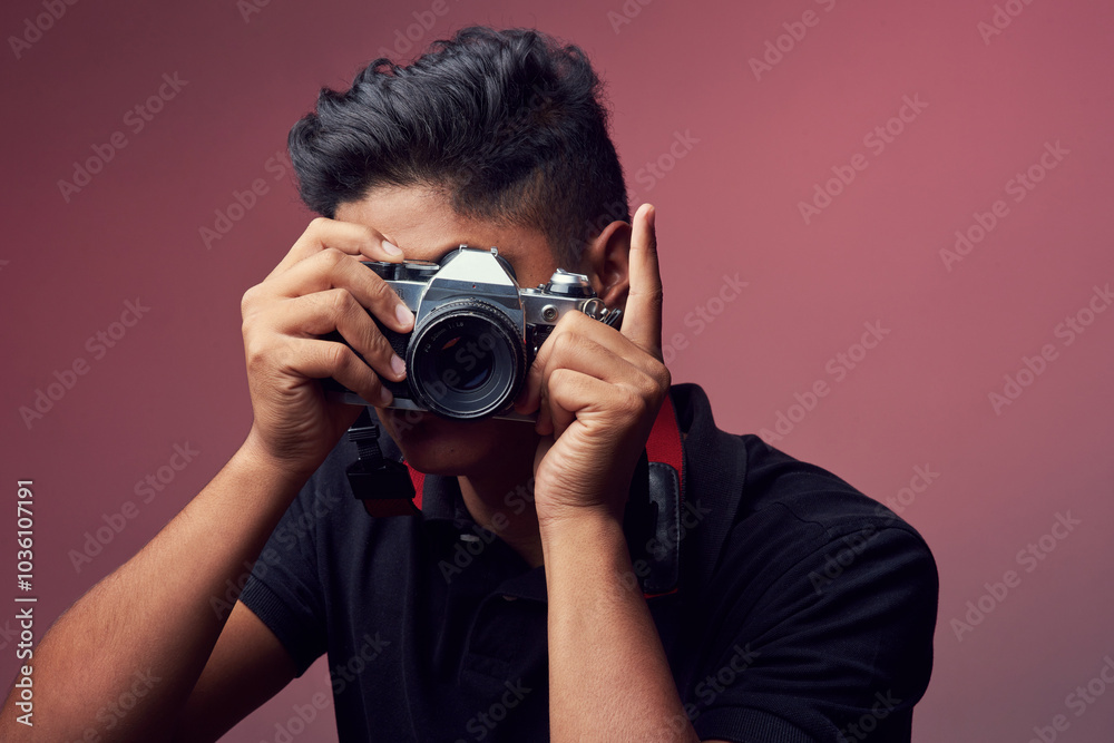 Studio, asian man and photography with camera lens for shooting, sightseeing or capture picture. Career, male person or journalist with retro equipment for photographer, production or pink background Studio, asian man and photography with camera lens for shooting, sightseeing or capture picture. Career, male person or journalist with retro equipment for photographer, production or pink background