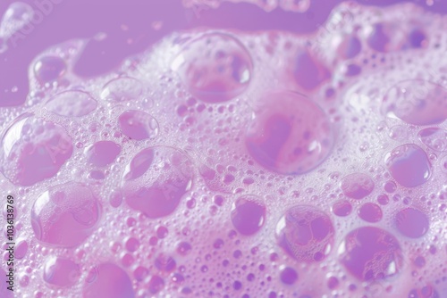 Bubbles of varying sizes float on a purple surface. Concept of cleanliness and freshness. For use in beauty product advertisements.