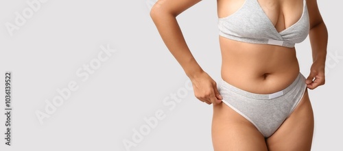 Beautiful young body positive woman on grey background. Banner for design