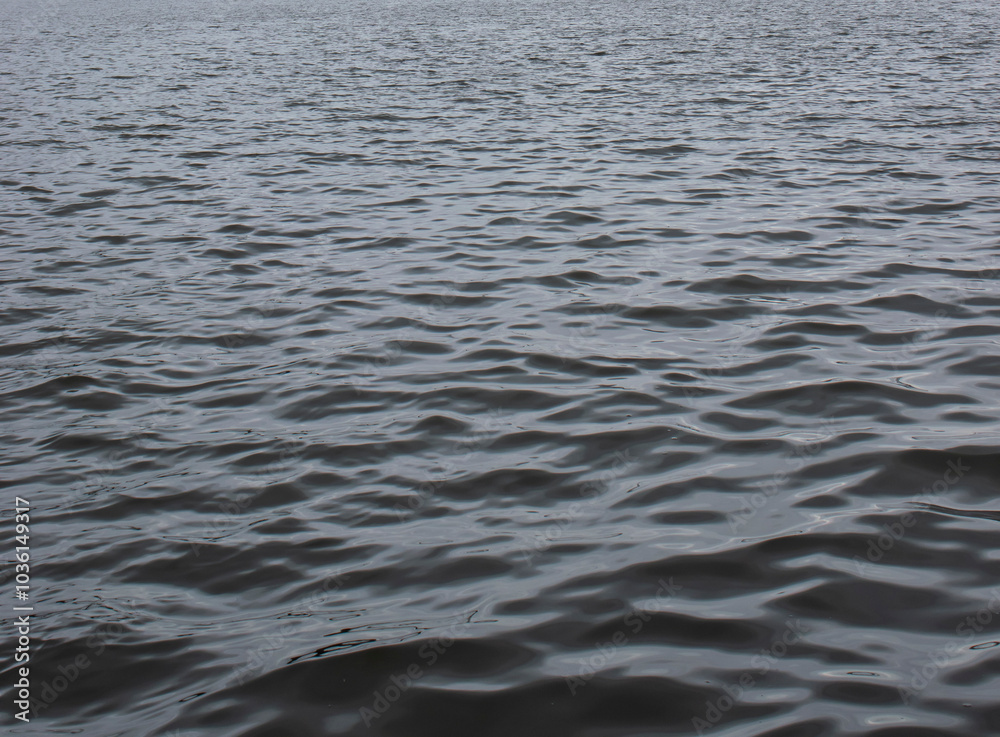 A serene view of rippling water's surface, capturing the calming essence of nature. Ideal for relaxation, meditation, or artistic backgrounds. A serene view of rippling water's surface, capturing the calming essence of nature. Ideal for relaxation, meditation, or artistic backgrounds.