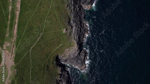 Bird eye moving forward over the ocean and rocks