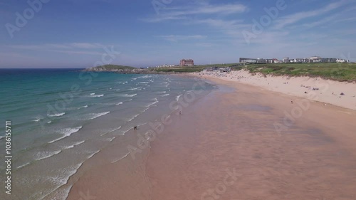 View of the beach in the morning. Flying over the waves close to the sand.