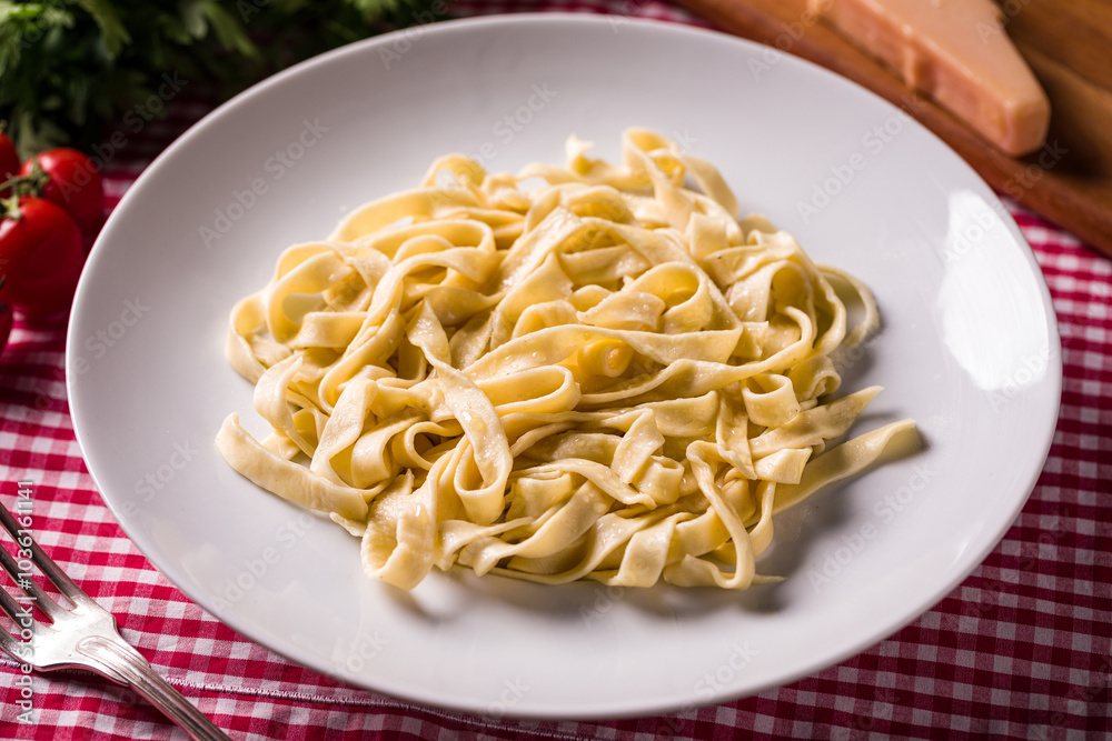 Delicious Homemade Fresh Pasta on Checkered Tablecloth Setting Delicious Homemade Fresh Pasta on Checkered Tablecloth Setting