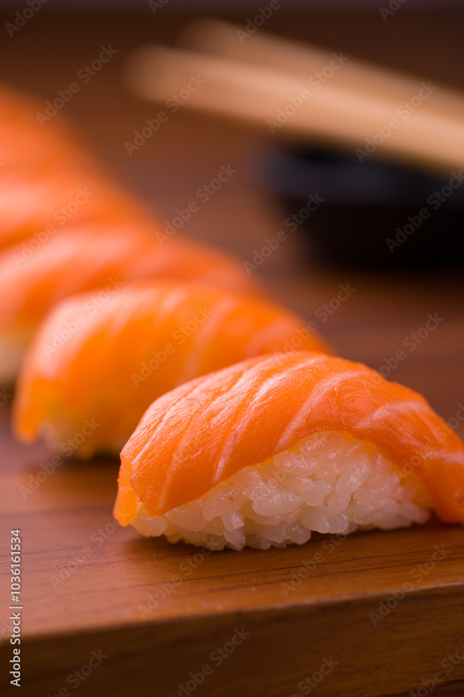 Close-Up of Fresh Salmon Nigiri Sushi on Wooden Board Close-Up of Fresh Salmon Nigiri Sushi on Wooden Board