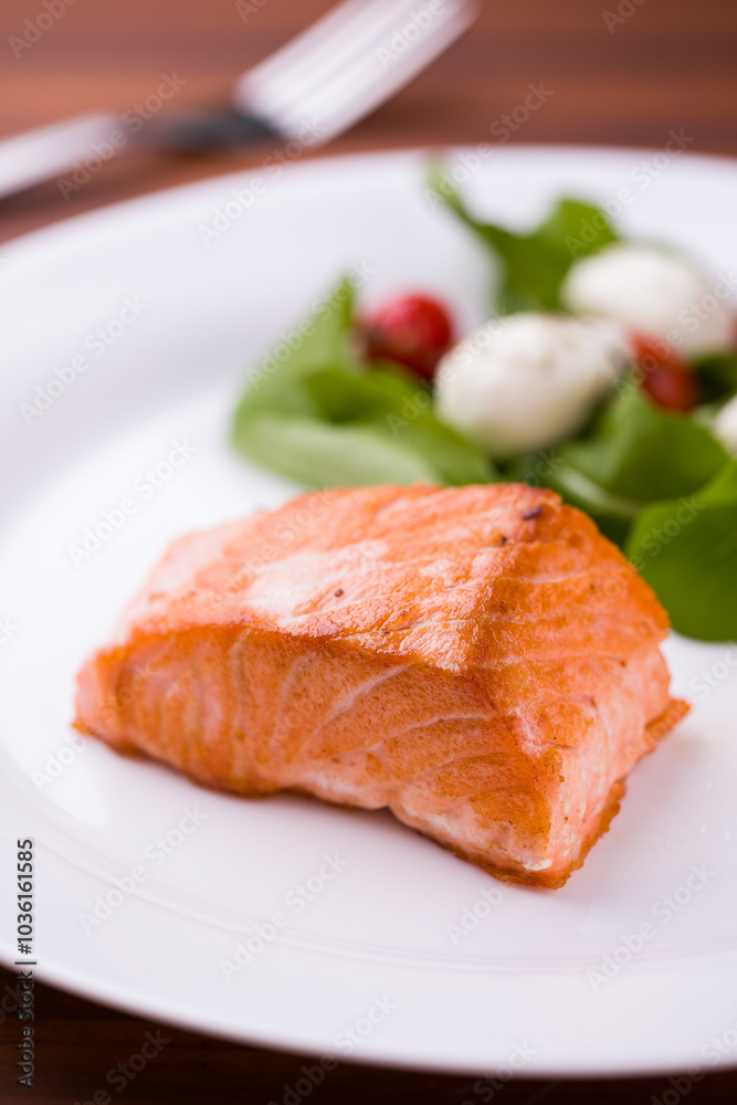 Delicious Grilled Salmon Fillet with Fresh Green Salad and Tomatoes Delicious Grilled Salmon Fillet with Fresh Green Salad and Tomatoes