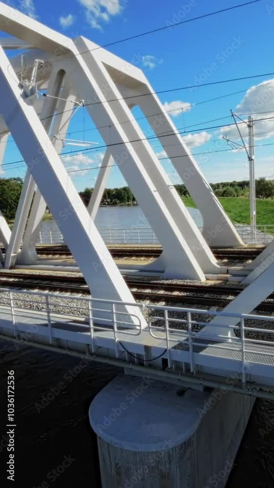 The video presents an inspection of the bridge over the Vistula river in Poland . It starts with a wide shot of the bridge, showing its overall structure and the surrounding area. The camera then pans