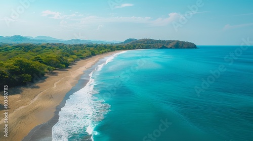 A breathtaking aerial view of a sunny seascape. The Mediterranean sea sparkles, waves gently rolling onto a sandy beach. Perfect summer vibes.