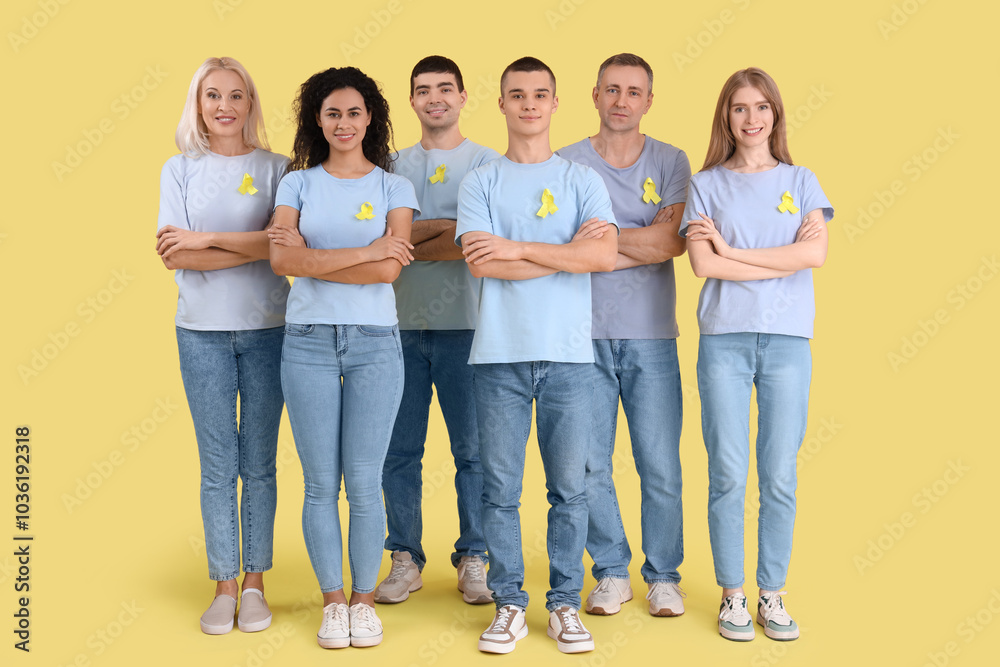 Obraz premium People with yellow awareness ribbons on color background. World Cancer Day