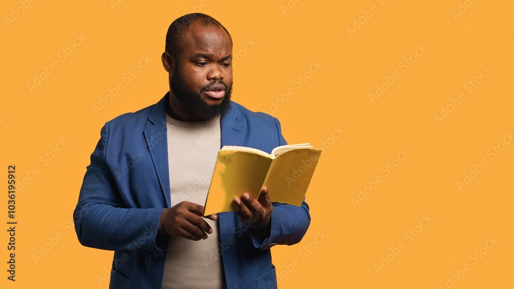 Man reading book aloud, narrating story for audience. Person enjoying literature novel, reciting from pages, entertaining spectators, isolated over studio background, camera A Man reading book aloud, narrating story for audience. Person enjoying literature novel, reciting from pages, entertaining spectators, isolated over studio background, camera A