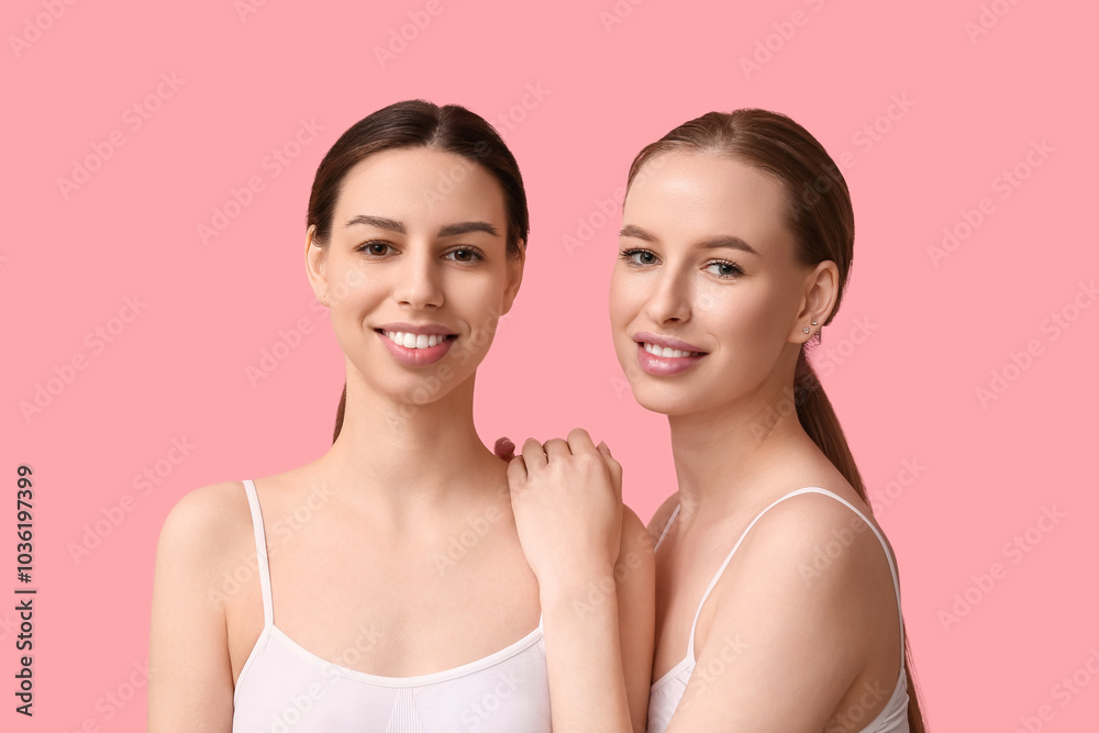 Beautiful young happy women with healthy skin on pink background